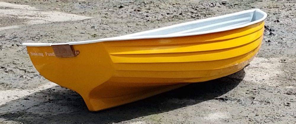 Yellow rowing boat on beach