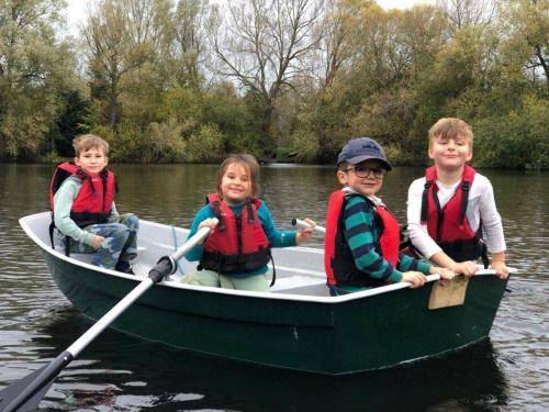 4 children having a load of fun in a row boat