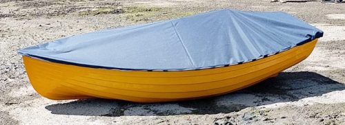 9.5ft rowing boat with grey cover on the beach.