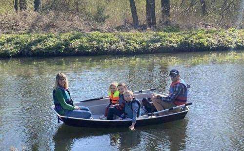 2 adults and 3 kids in a boat
