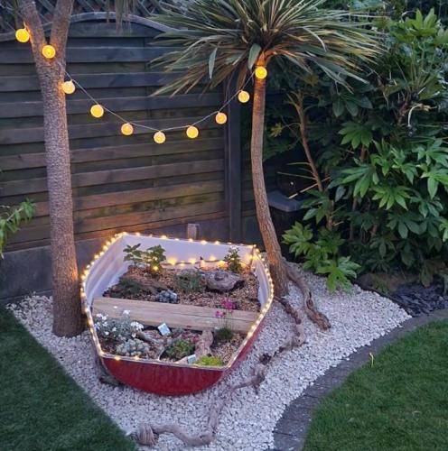 garden boat planter at night